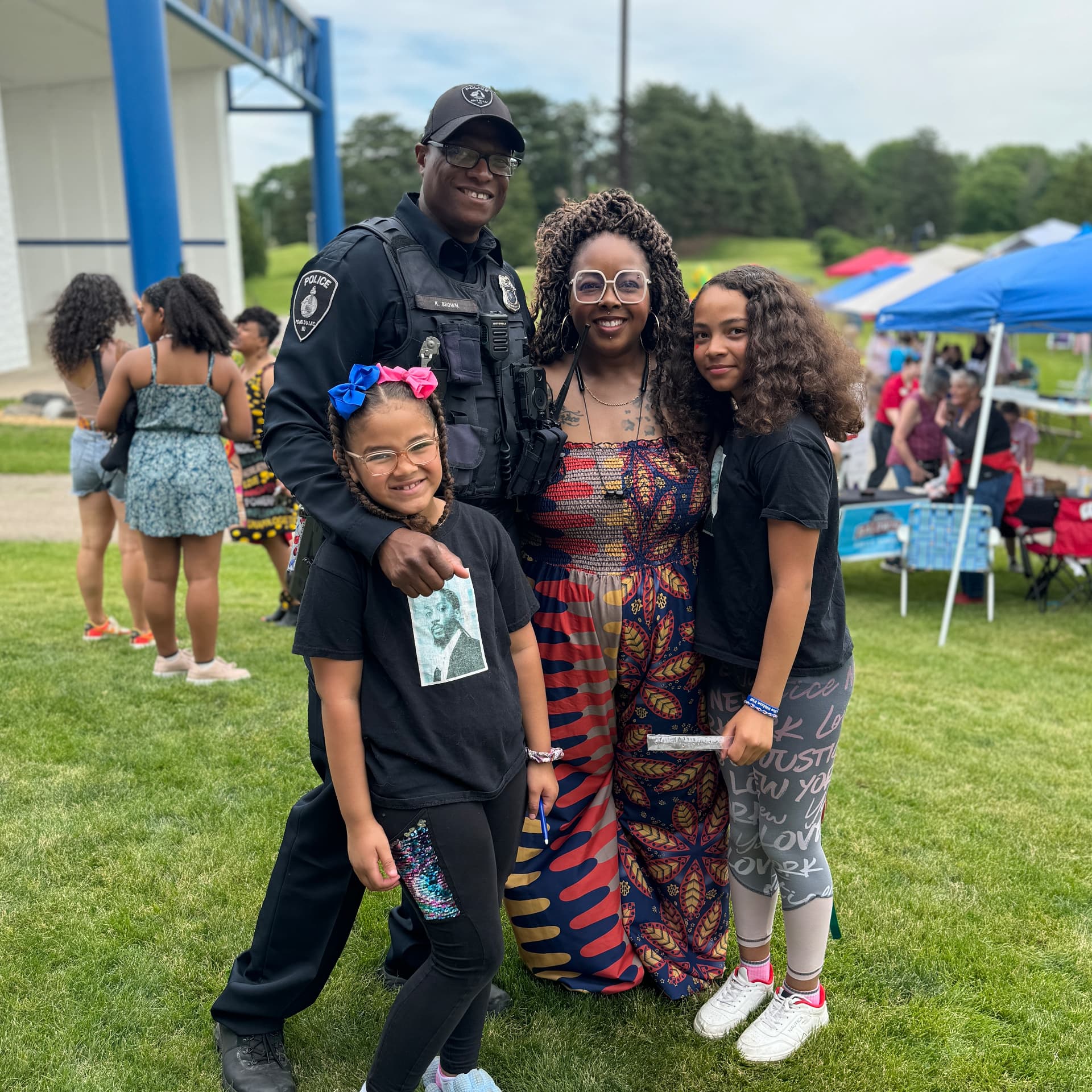 Officer Keywon Brown with a family at a Fond du Lac community celebration.